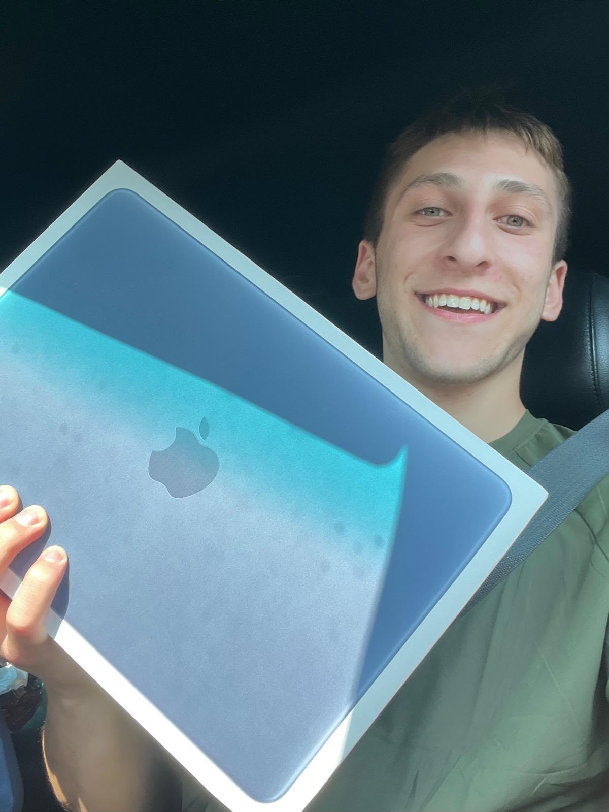 JJ Ostroff holding his new MacBook Neo